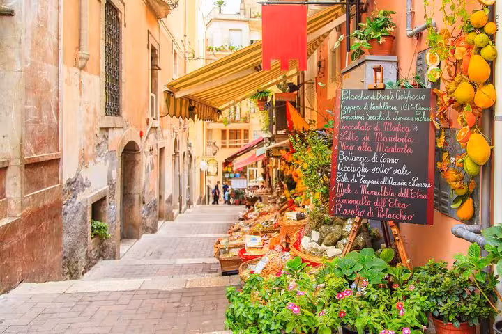 Vibrant street market in Taormina showcasing local produce and crafts, ideal for exclusive shore excursion tours.
