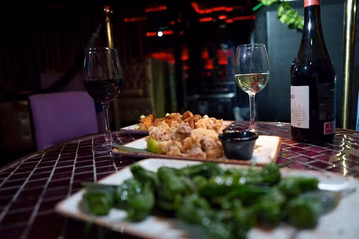 Delicious tapas with wine, featuring a vibrant spread of traditional Spanish cuisine at a Barcelona flamenco show.