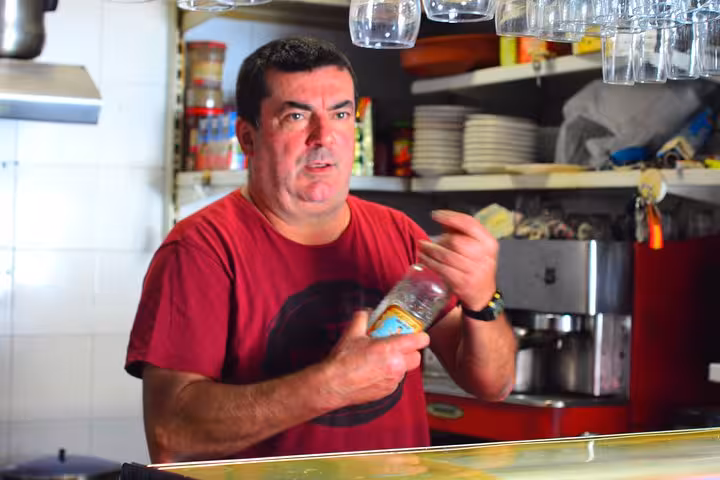 Local bartender prepares drinks during the Taste of Marbella Food & Market Small Group Tour experience.