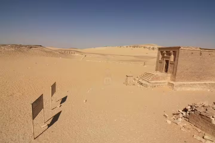 Desert view of Tell el-Amarna ruins with ancient temple doorway, ideal for a private day tour in Egypt