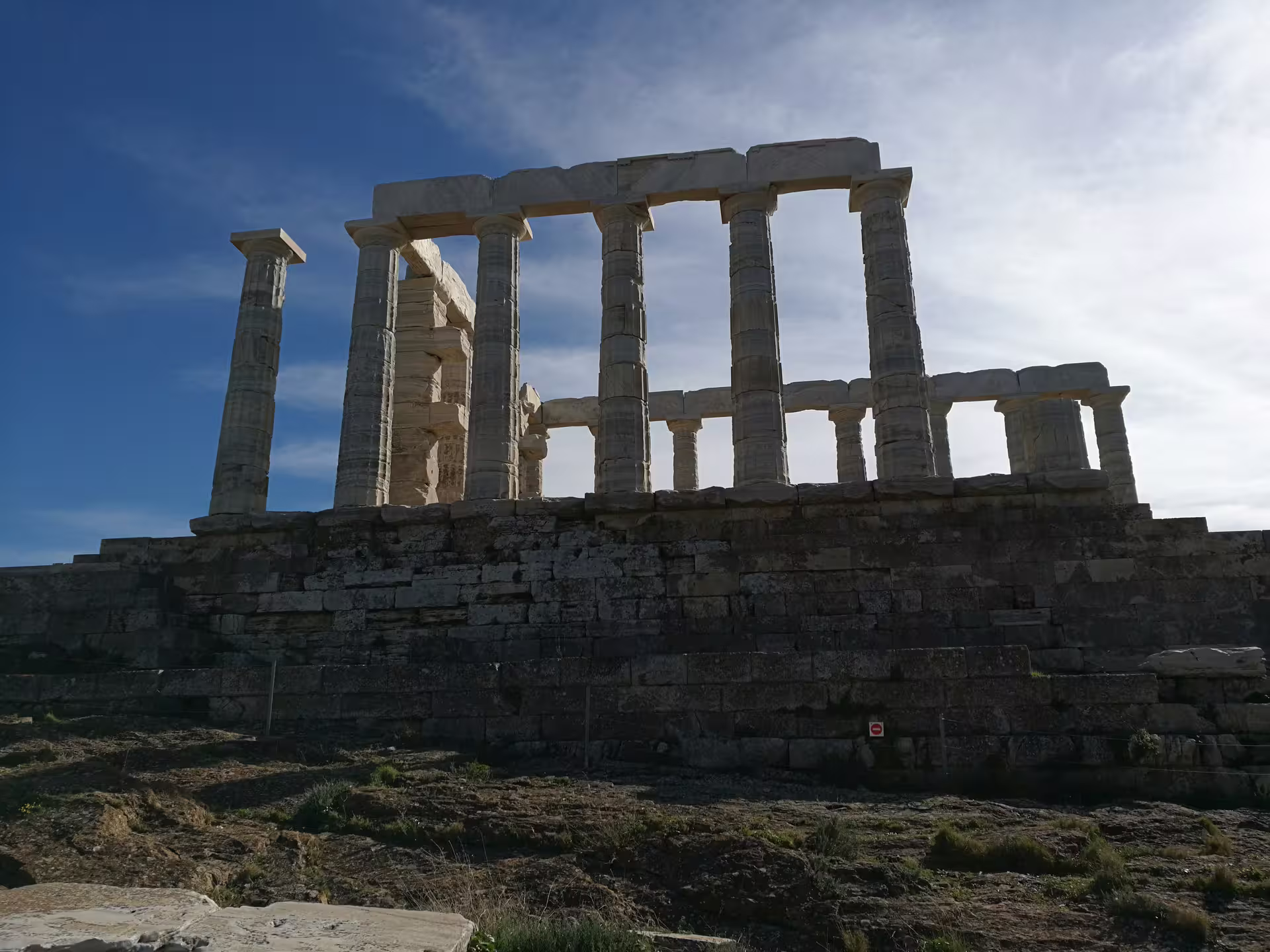 Temple of Poseidon at Cape Sounion under blue sky, highlight of private sunset tour from Athens
