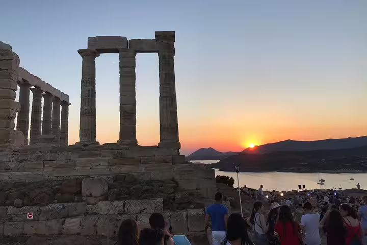 Temple of Poseidon at Cape Sounion glowing at sunset on a small-group half-day tour from Athens