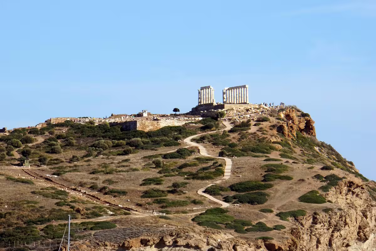 Temple of Poseidon at Cape Sounion atop cliff, scenic stop on private Athens Riviera sunset tour