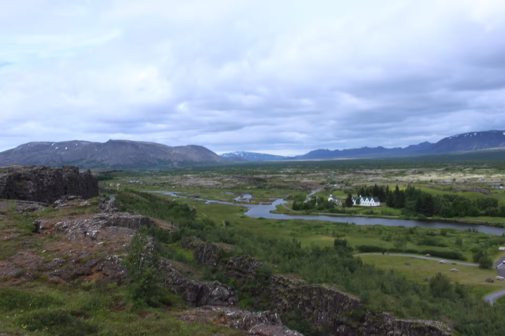 Expansive view of Thingvellir National Park's lush landscape, showcasing rivers and cliffs on the Silfra Superjeep Golden Circle tour.