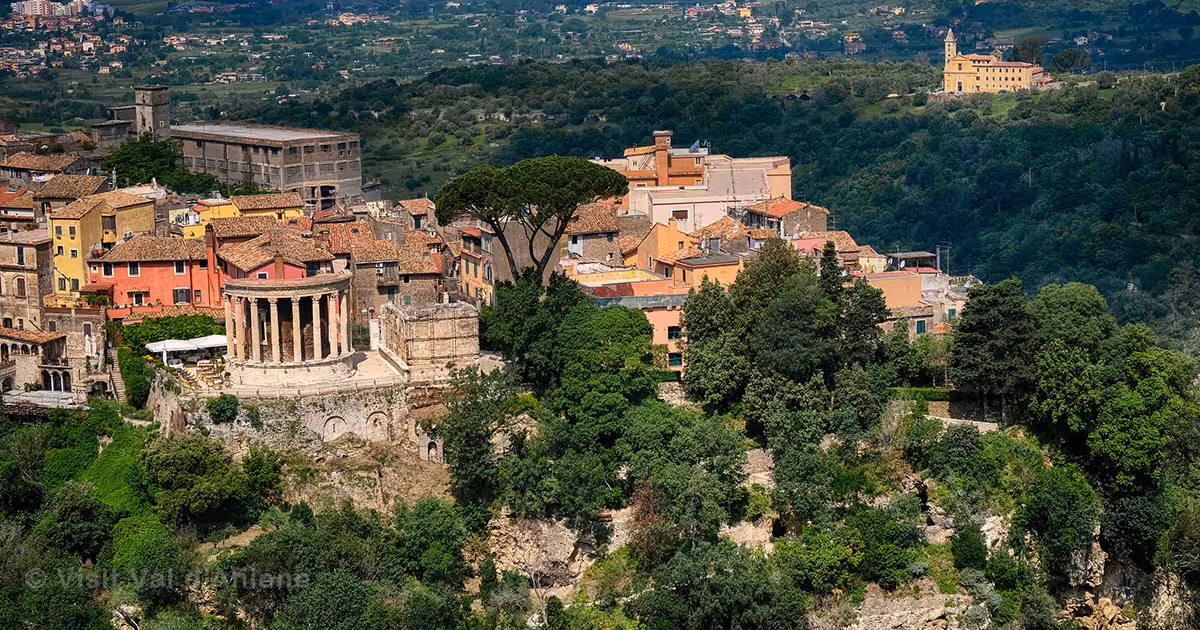 Aerial view of Tivoli's historic villas and temples set against a backdrop of lush greenery and vibrant buildings.