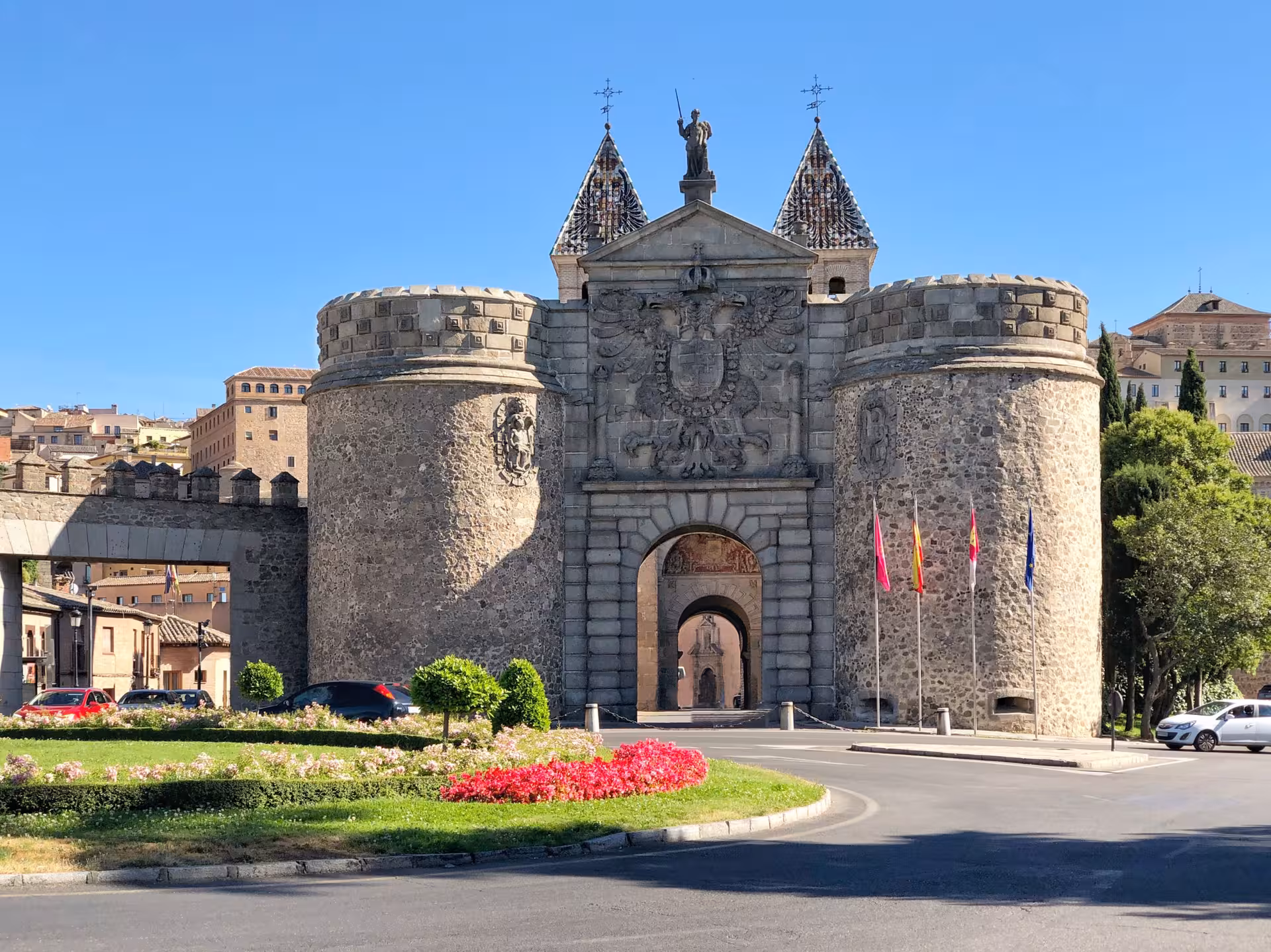 Impressive medieval architecture of Toledo's Puerta de Bisagra illuminated by sunlight on Andalusia tour from Madrid.