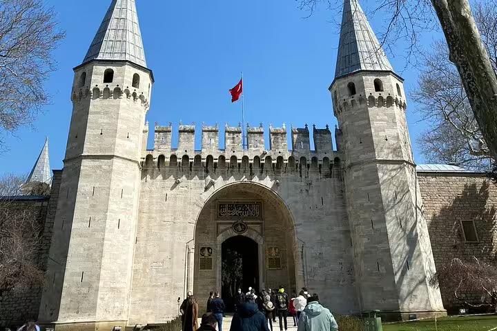 Topkapi Palace Imperial Gate in Istanbul with visitors and Turkish flag on a 10-day private guided Turkey tour
