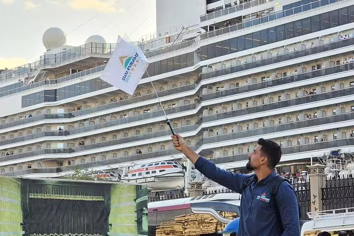 Tour guide at Ain Sokhna Port meeting cruise guests for Giza Pyramids and Grand Egyptian Museum day trip