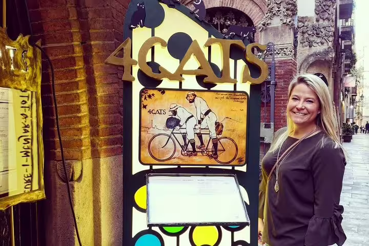 Smiling tourist at El Quatre Gats, Barcelona, a historic spot linked to Gaudi, during a private Sagrada Familia tour.