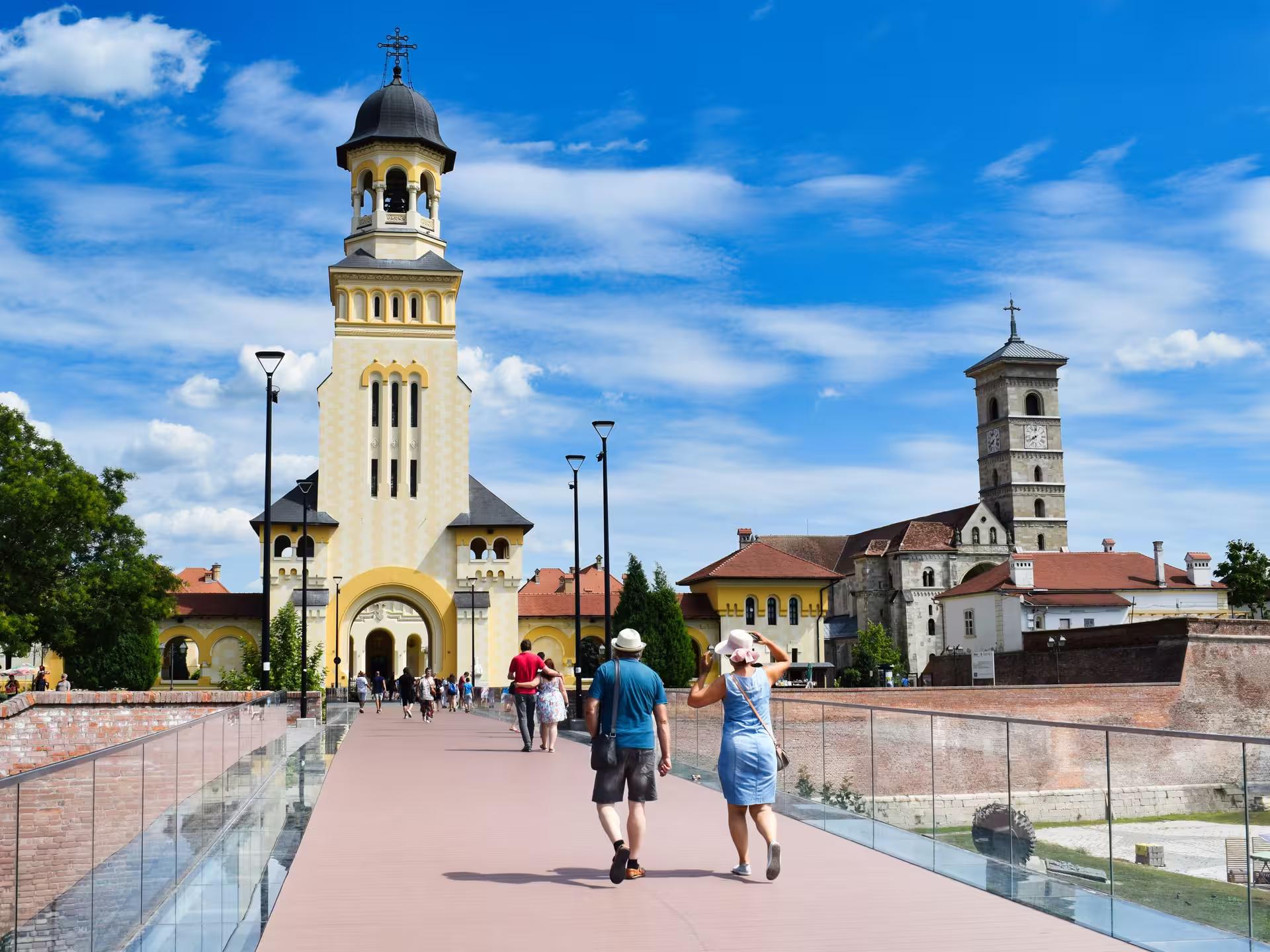 Tourists walking toward Alba Iulia Cathedral on a Best of Transylvania guided tour of Saxon towns