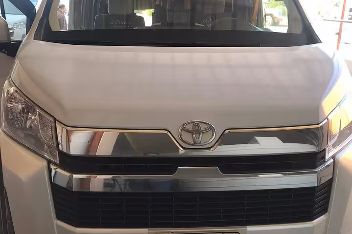 Front view of Toyota van used for private Luxor International Airport transfer with door-to-door service