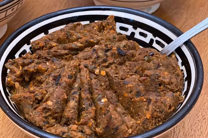 Traditional dish with spicy flavors served in a decorative bowl at a cooking class for authentic culinary experiences.