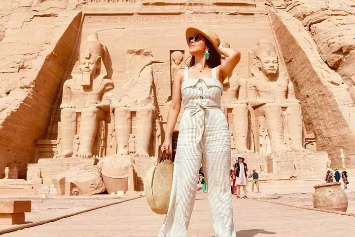 Traveler in sunhat at Abu Simbel Great Temple entrance, perfect stop on an Aswan to Abu Simbel day tour