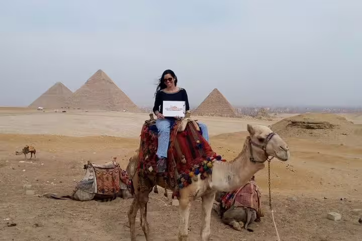 Traveler on camel by the Great Pyramids of Giza, classic experience on a 3-day private Cairo tour package