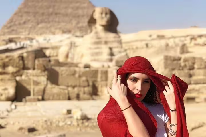Traveler in red scarf with Great Sphinx and Giza Pyramid backdrop on Cairo pyramids day tour experience