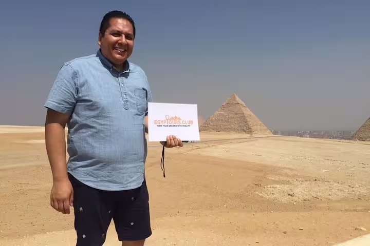 Traveler at Giza Pyramids viewpoint on private Cairo tour by plane from Sharm El-Sheikh, Egypt day trip