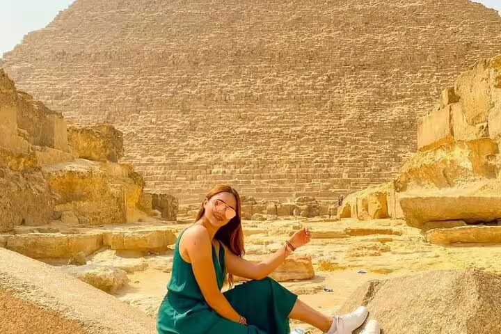 Traveler posing by the Great Pyramid of Giza during pyramids tour with museum visit and dinner cruise combo