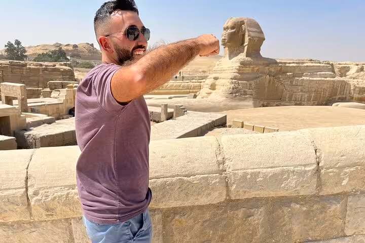 Traveler posing with the Great Sphinx viewpoint on VIP Giza Pyramids Wonders tour and Grand Egyptian Museum