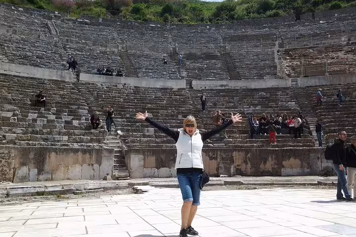 Traveler posing inside the Great Theatre on a private Ephesus shore excursion from Kusadasi Port, Turkey