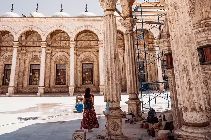 Traveler in historic mosque courtyard in Islamic Cairo, a cultural stop on Four Seasons luxury Cairo travel
