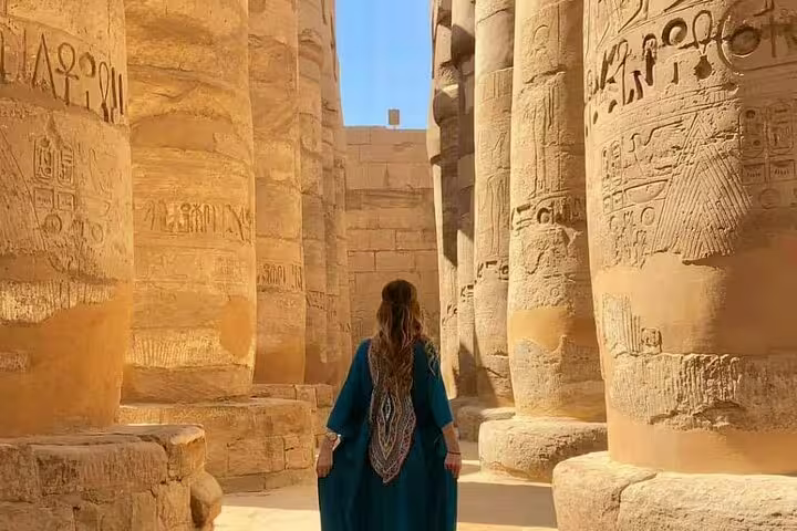 Traveler in Karnak Temple column hall, Luxor on 3 nights 2 days tour from Cairo by sleeper train