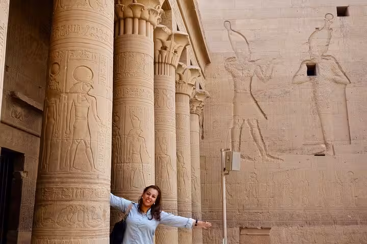 Traveler at Kom Ombo Temple columns in Aswan, highlight of Luxor to Abu Simbel overnight trip