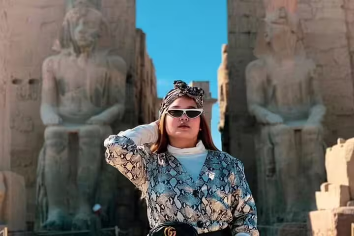 Traveler at Luxor Temple entrance between colossal statues on private day tour from Safaga Port