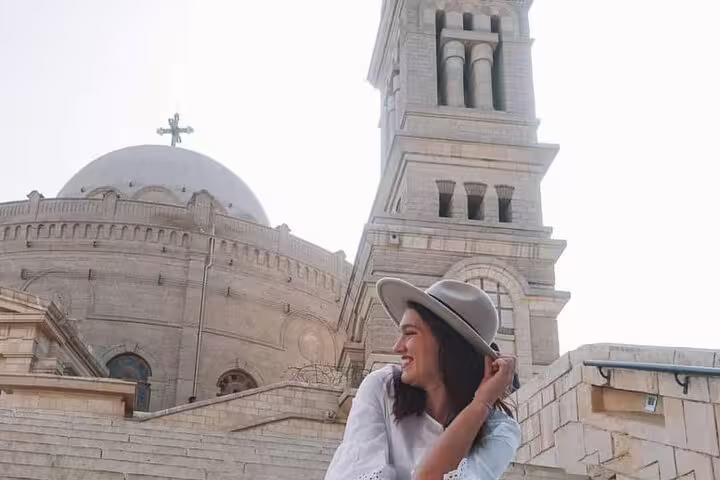 Traveler at Old Cairo Coptic church with dome and bell tower, part of Egyptian Museum, Citadel and Old Cairo day tour