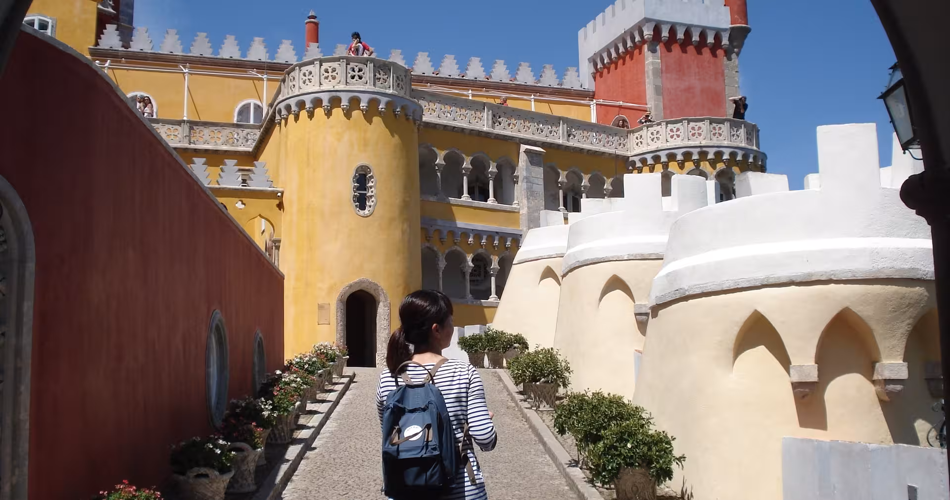 Traveler walking inside Pena Palace, Sintra, on Lisbon & Sintra full-day tour featuring UNESCO landmarks