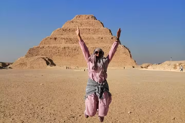 Traveler jumping at Saqqara Step Pyramid on VIP Giza Pyramids tour with Grand Egyptian Museum visit
