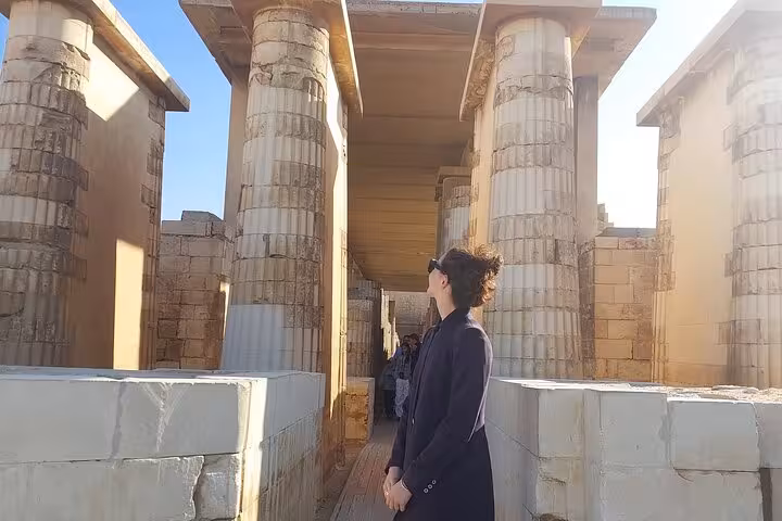 Traveler by Saqqara temple columns on Giza, Sphinx and Serapeum day tour from Cairo with guide