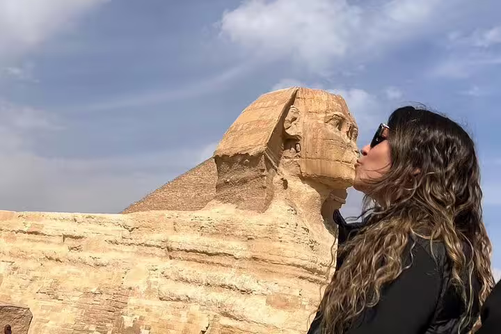 Traveler kissing the Great Sphinx at Giza on an El Sokhna Port shore excursion with Nile lunch cruise in Cairo