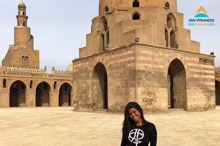 Traveler at Sultan Hassan Mosque courtyard, Cairo stop on 8-day Luxor Nile cruise and Cairo tour package