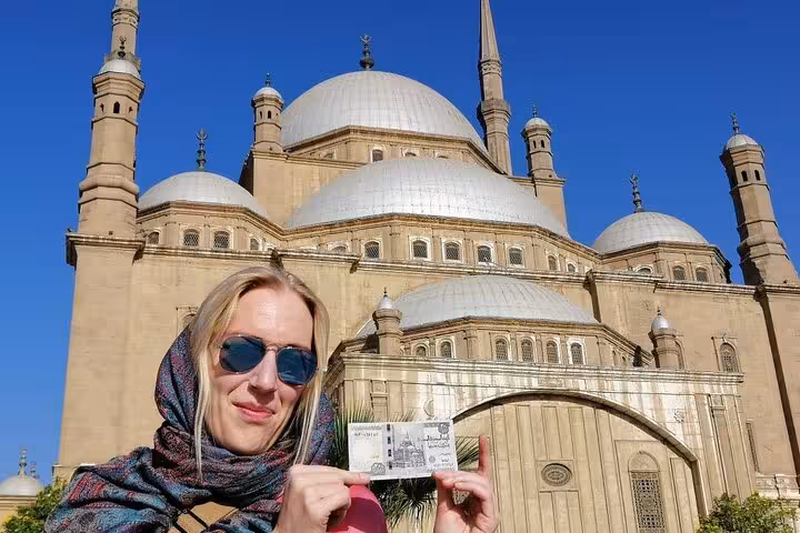 Traveler holding ticket at Mosque of Muhammad Ali, key stop on Islamic and Coptic Cairo day tour in Egypt
