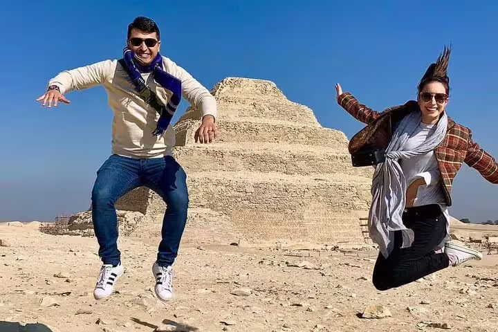 Travelers jumping by Saqqara Step Pyramid on a private Alexandria port shore excursion to Giza and Saqqara