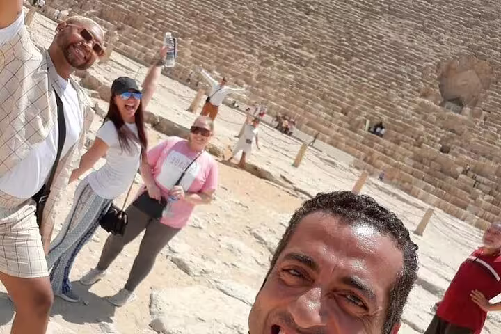 Travelers selfie at the Giza Pyramid plateau during a private day tour to the Pyramids and Grand Egyptian Museum