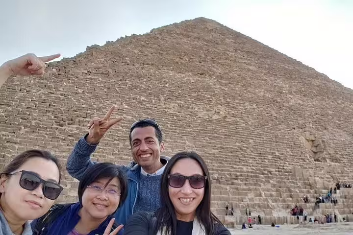 Travelers selfie at the Great Pyramid of Giza on a private day tour, Cairo with expert guide and museum visit