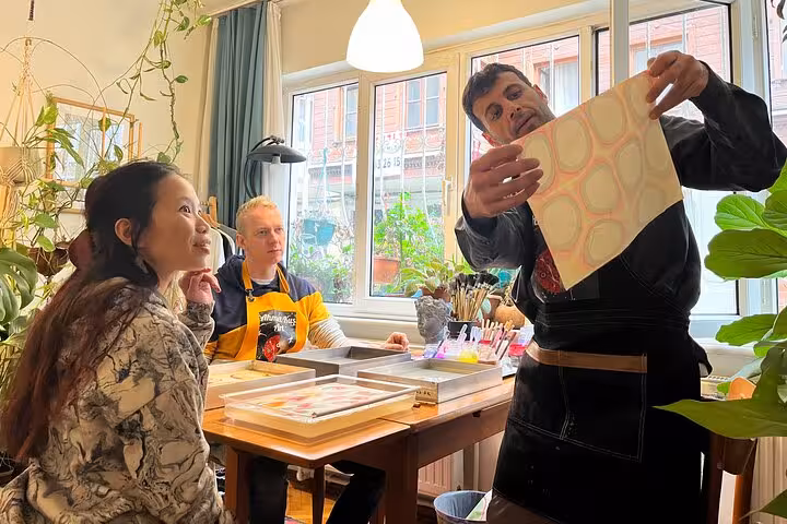 Travelers learning Turkish marbling art in an Istanbul neighborhood studio during a 3-day local immersion trip