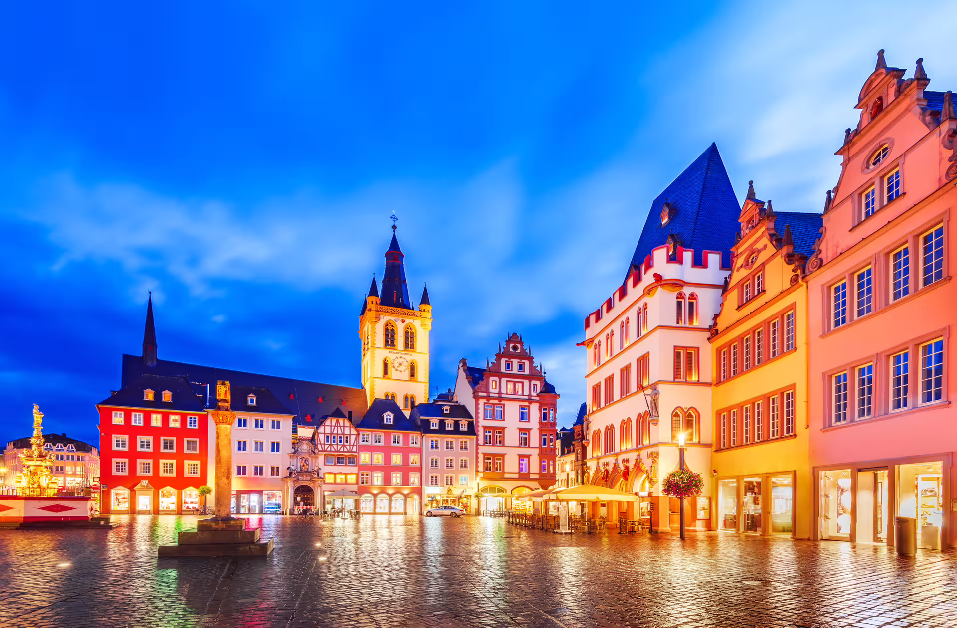 Evening view of Trier Hauptmarkt with lit facades, featured on a 1-day walking tour with audioguide