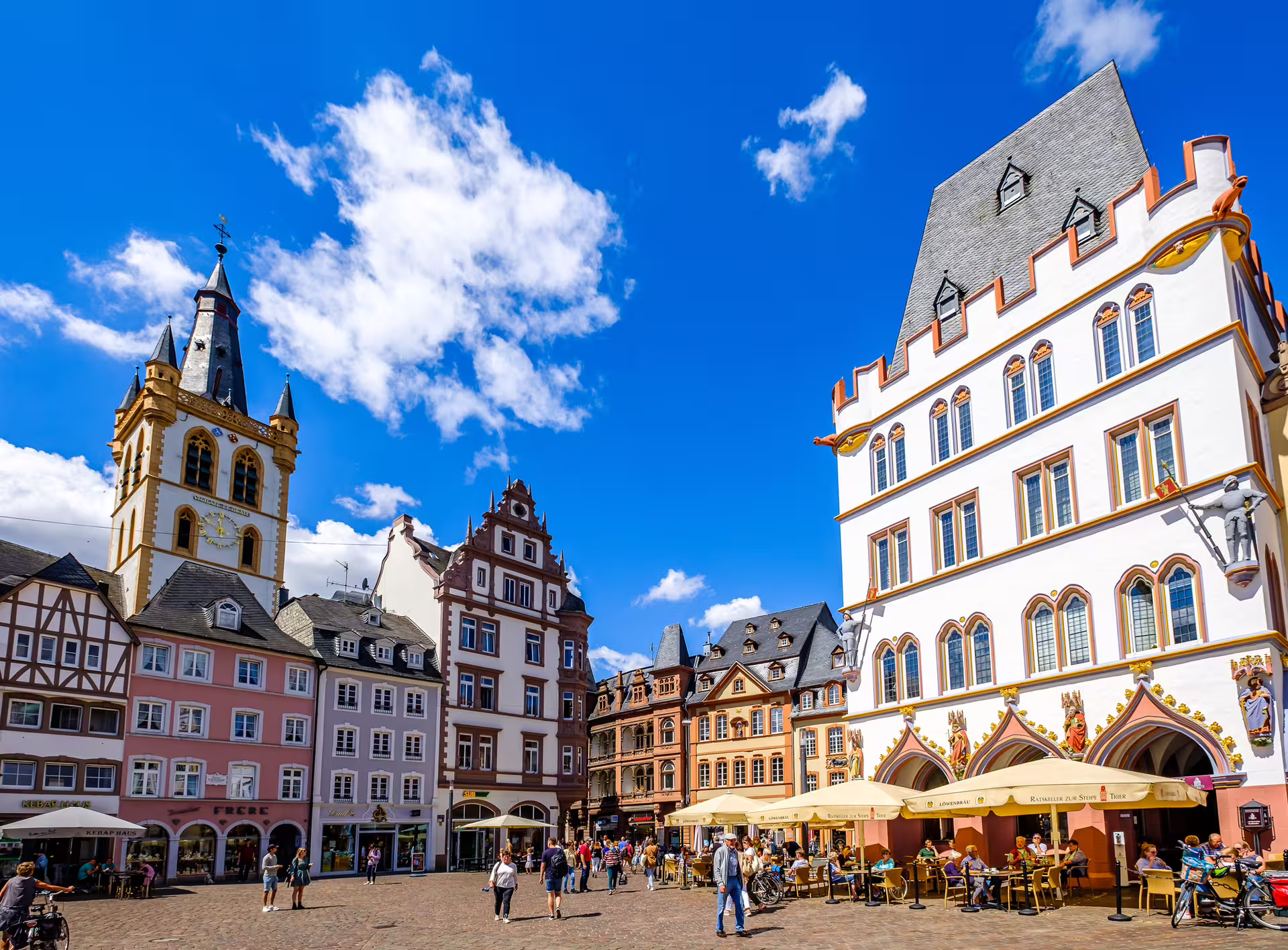 Trier Hauptmarkt square with colorful historic facades and cafés, featured on Trier in 1 Day walking tour audioguide