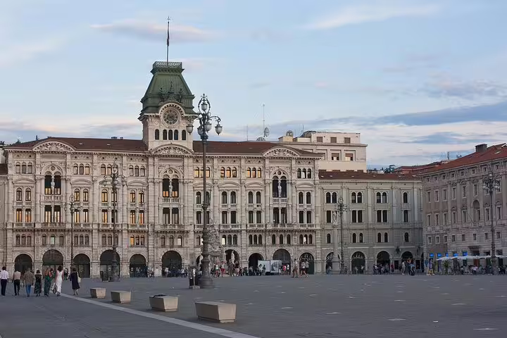 Piazza Unità d’Italia in Trieste at dusk, showcasing Habsburg-era palaces visited on a private walking tour with local guide