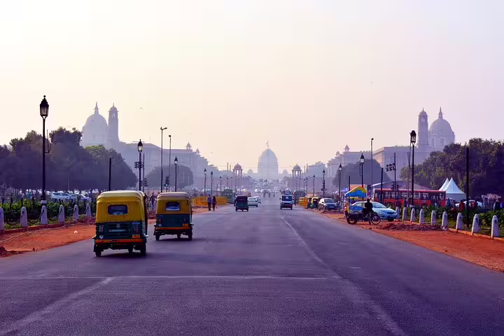 Tuk tuk tour in Egypt on a wide city boulevard at sunset, passing landmarks and busy local traffic