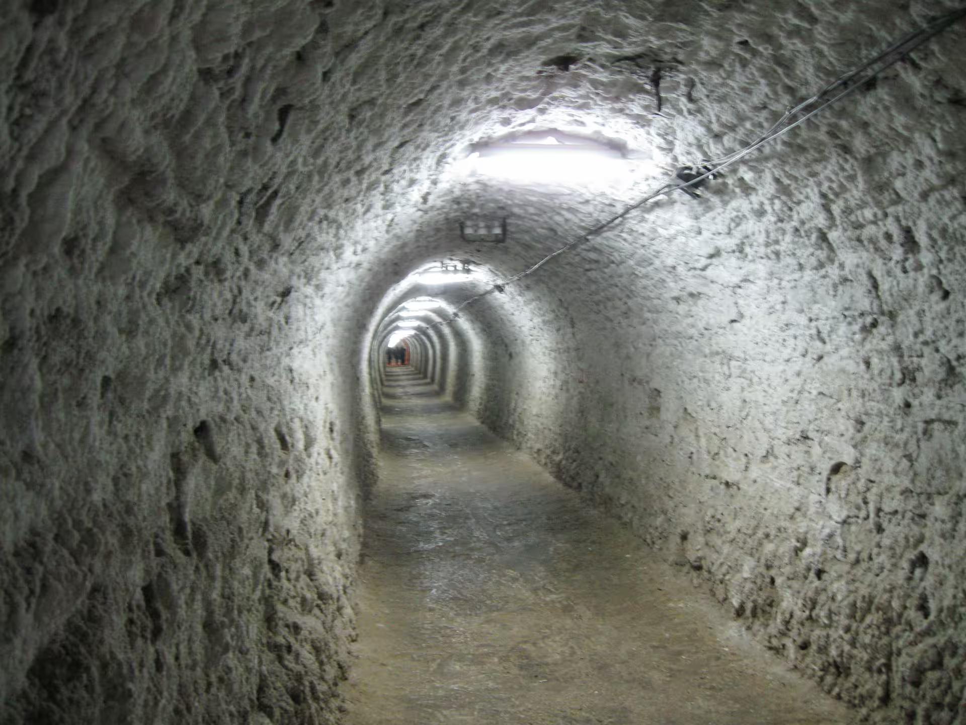 Long arched salt tunnel passage deep underground at Turda Salt Mine guided tour from Cluj