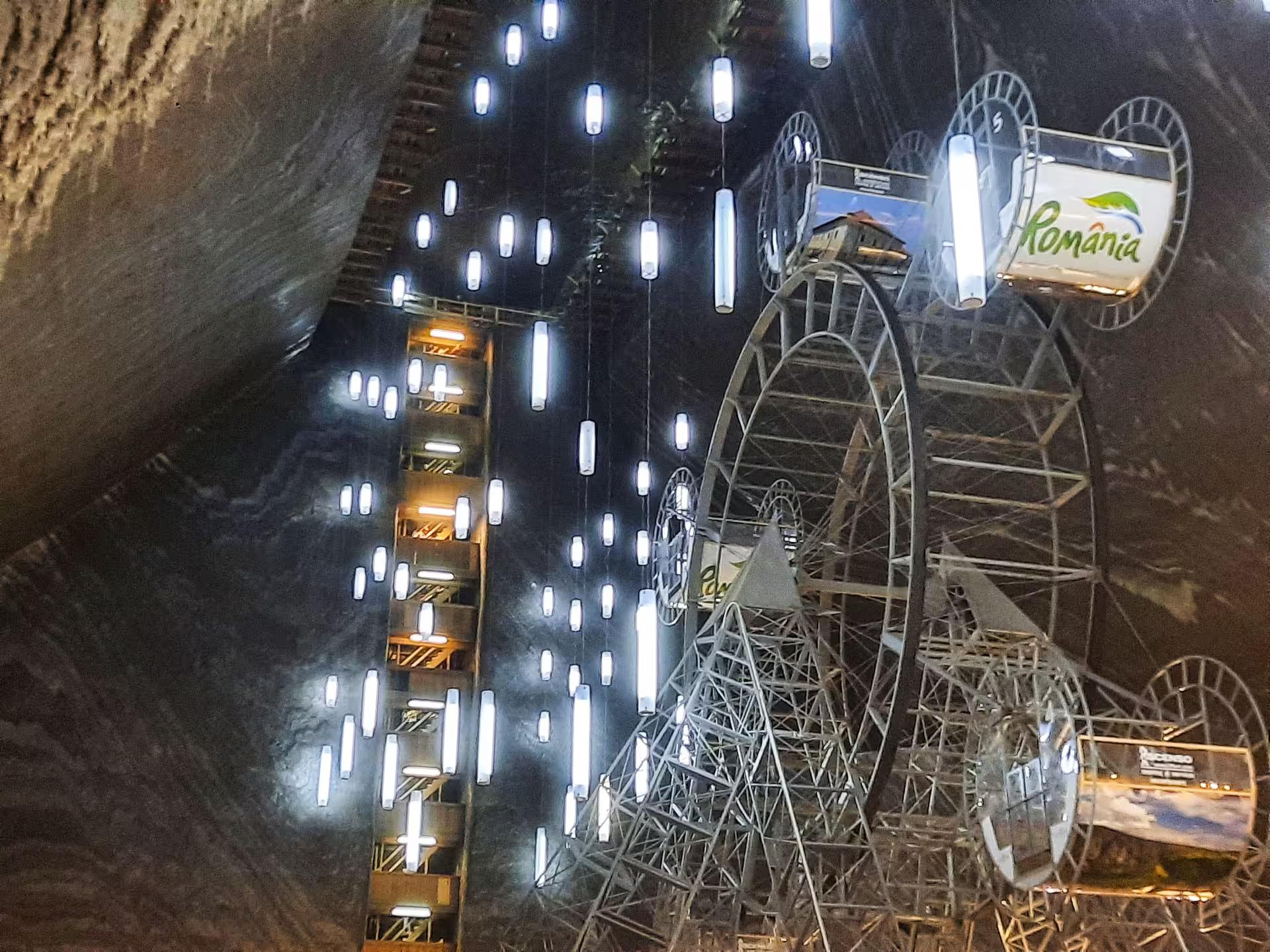 Turda Salt Mine underground Ferris wheel and illuminated attractions inside the historic Romanian salt cavern on a guided day tour