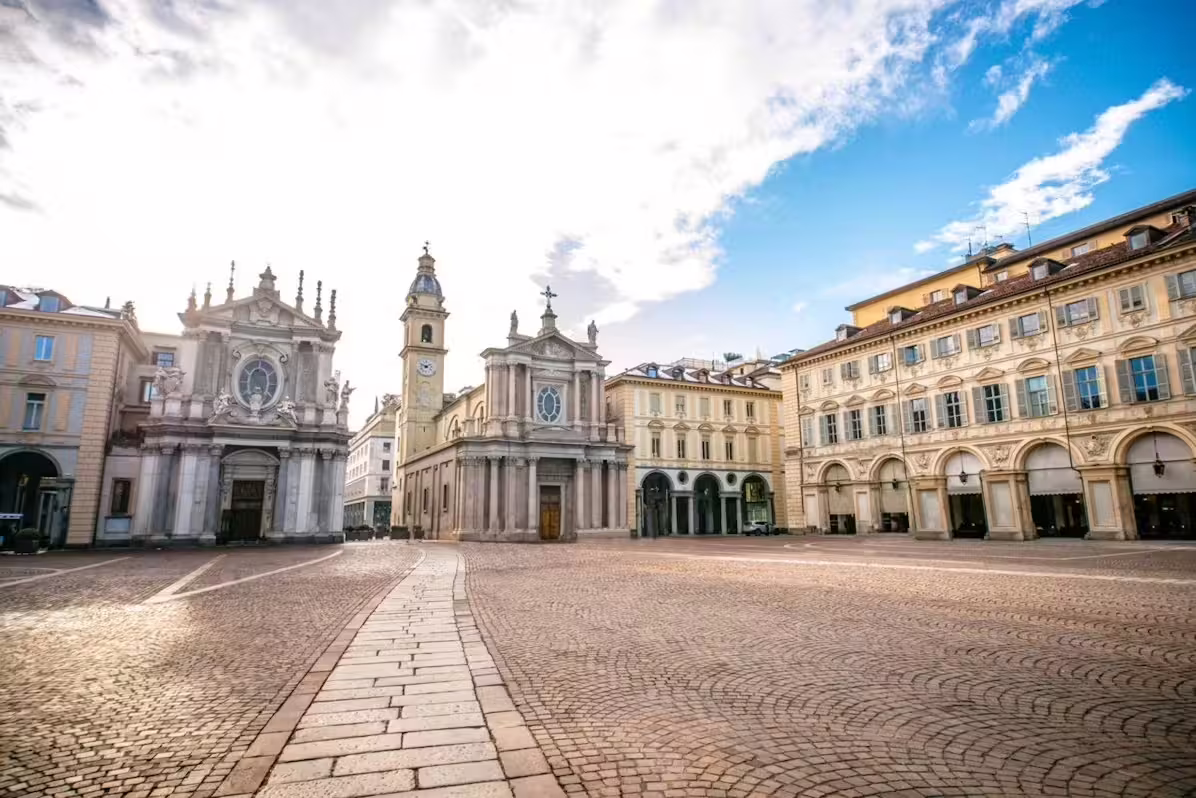 Sunlit Piazza San Carlo in Turin with baroque churches and arcades, featured on a private tour with Egyptian Museum tickets