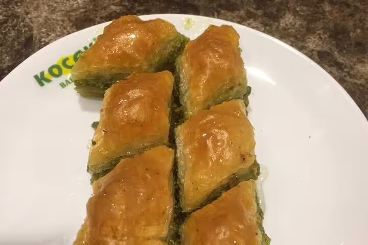 Traditional pistachio baklava dessert on a plate, Turkish cuisine tasting during 10-day private Turkey tour