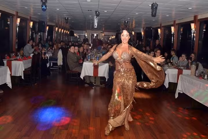 Belly dancer performing on Turkish night dinner cruise boat, entertaining guests with live show and music