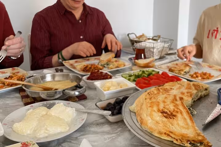 Homemade Turkish breakfast spread in Istanbul home, sharing börek, olives and tea on local life tour