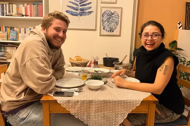 Travelers share a homemade Turkish dinner with a local host in Istanbul city center after a cooking class
