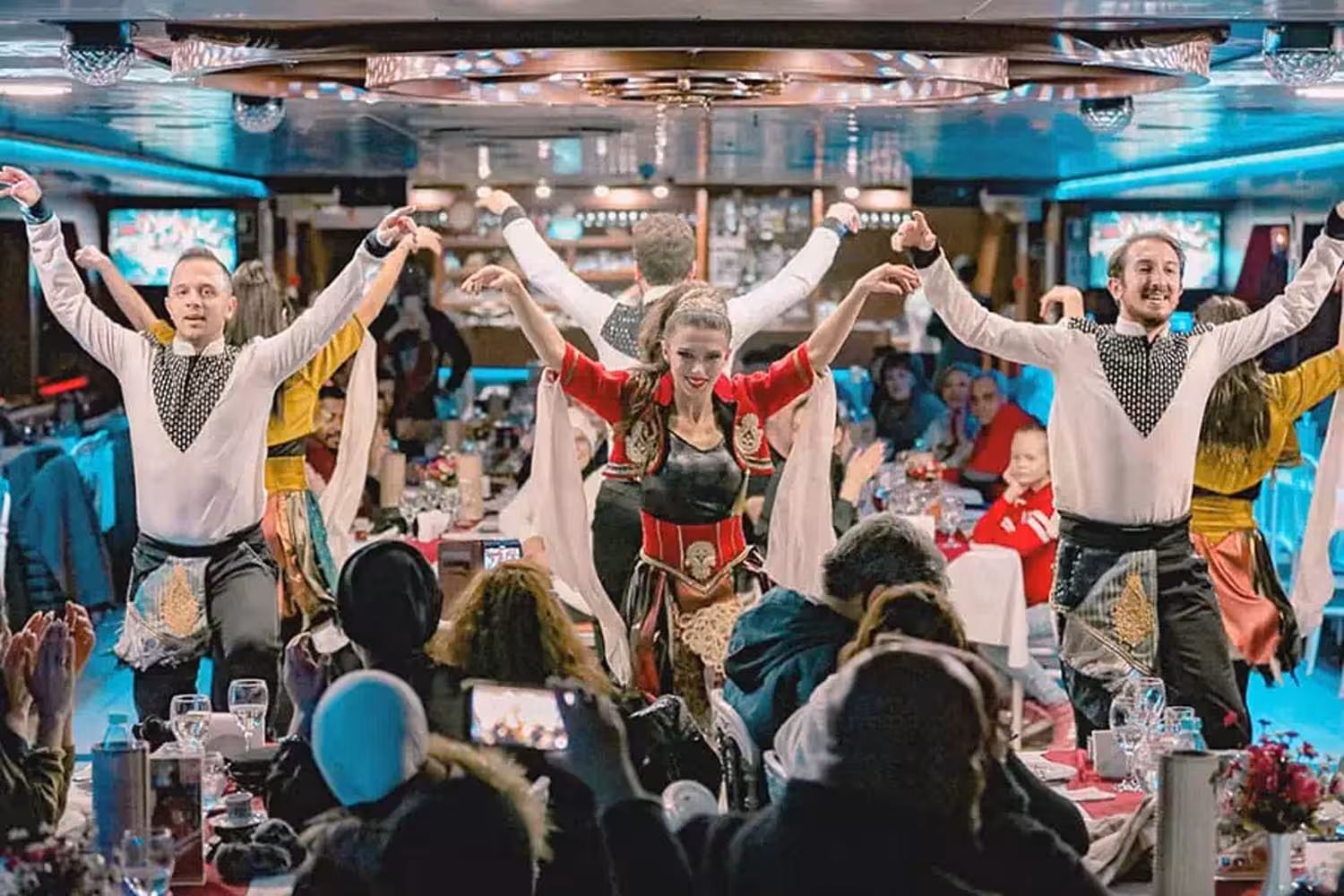 Turkish folk dance show with live entertainment during Bosphorus dinner cruise in Istanbul at night